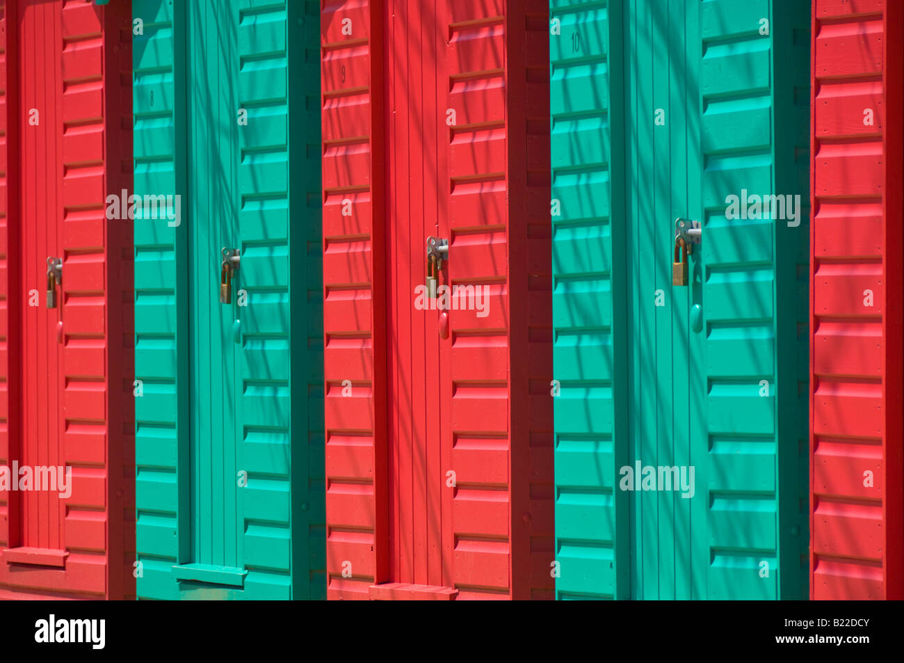 Red and green painted beach huts on Llanbedrog beach Llyn peninsula Gwynedd North Wales UK GB EU Europe Stock Photo