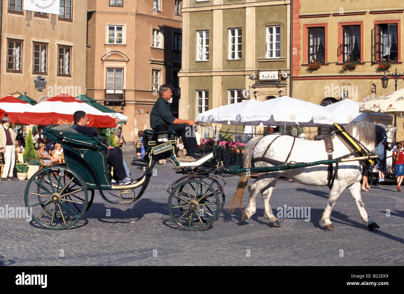 Horse drawn vehicle on tour with tourists on the Old Town Square Warsaw Poland Stock Photo