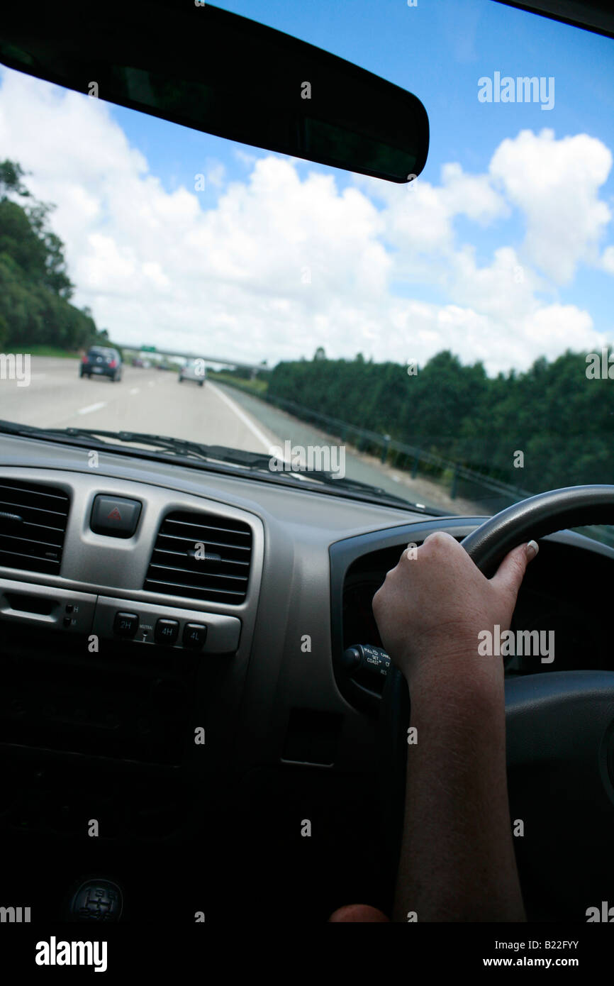 Sitting in the passenger seat driving fast in a car on the highway