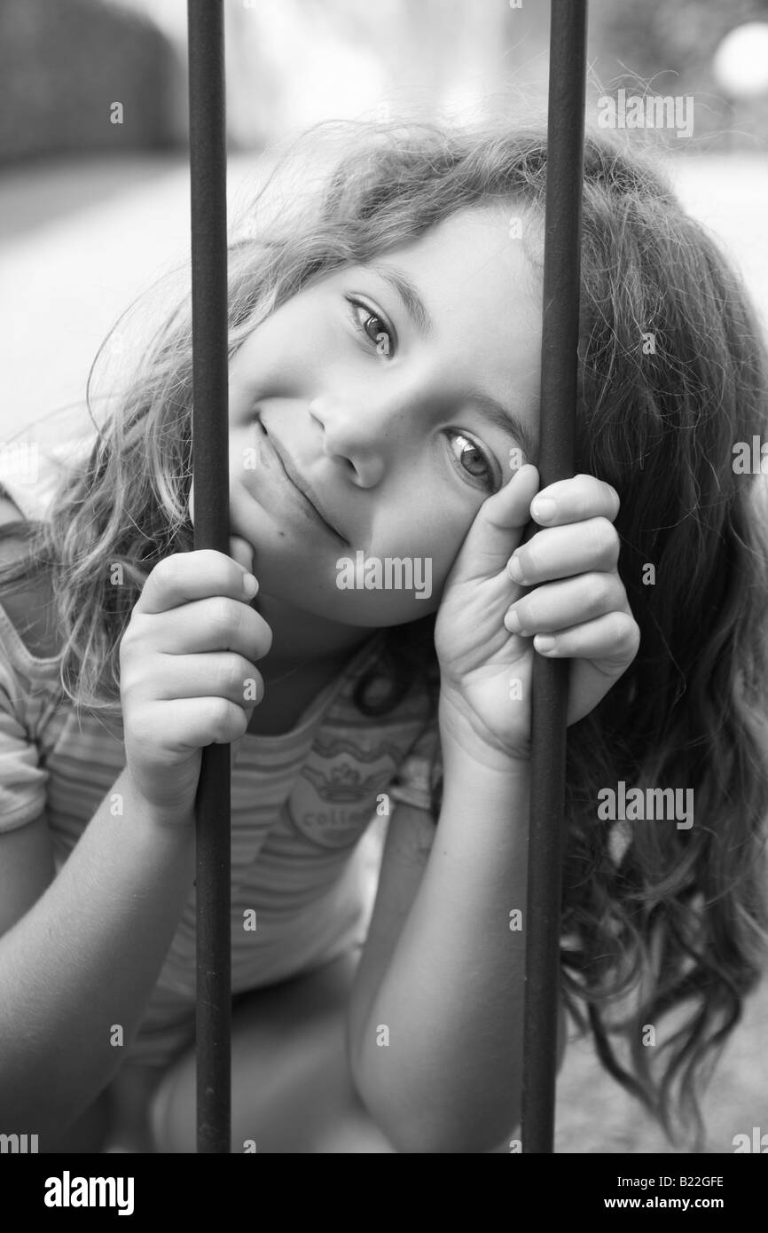 Pretty child portrait behind bars Stock Photo Alamy