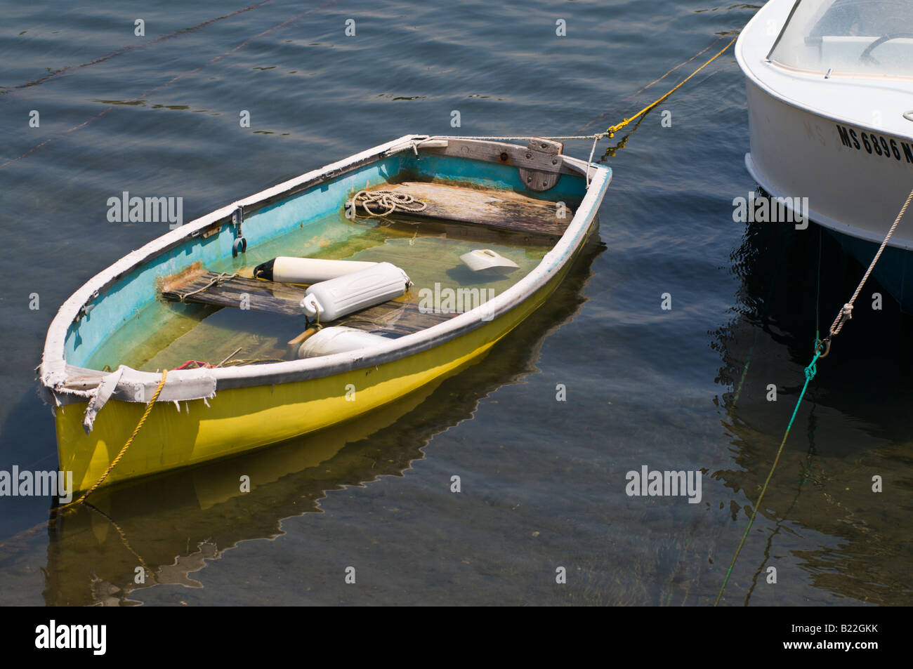 a dinghy filling up with water. Stock Photo