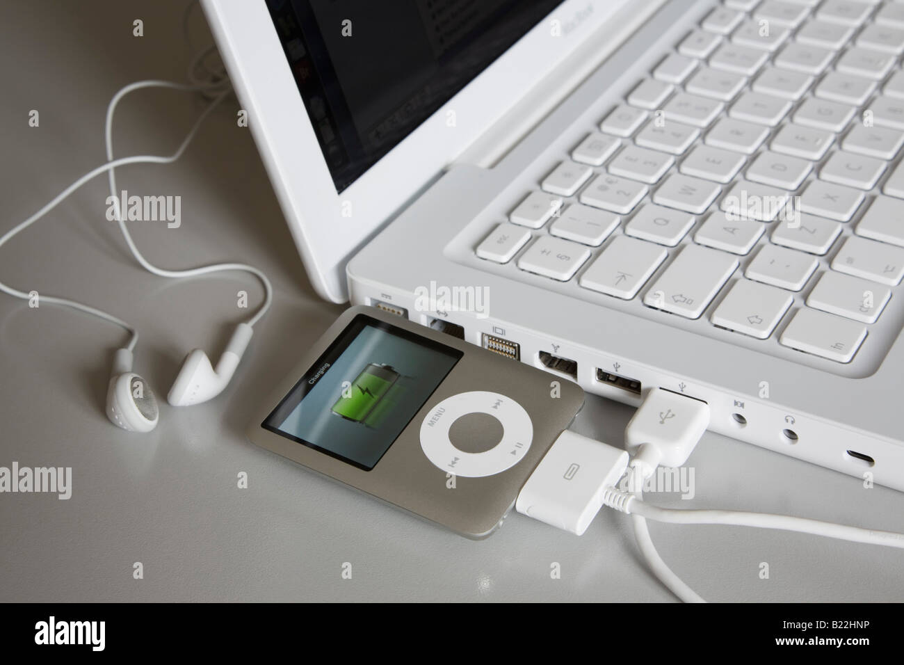 Apple ipod Nano 3rd generation MP3 player connected to white MacBook laptop  computer USB port to charge battery Stock Photo - Alamy