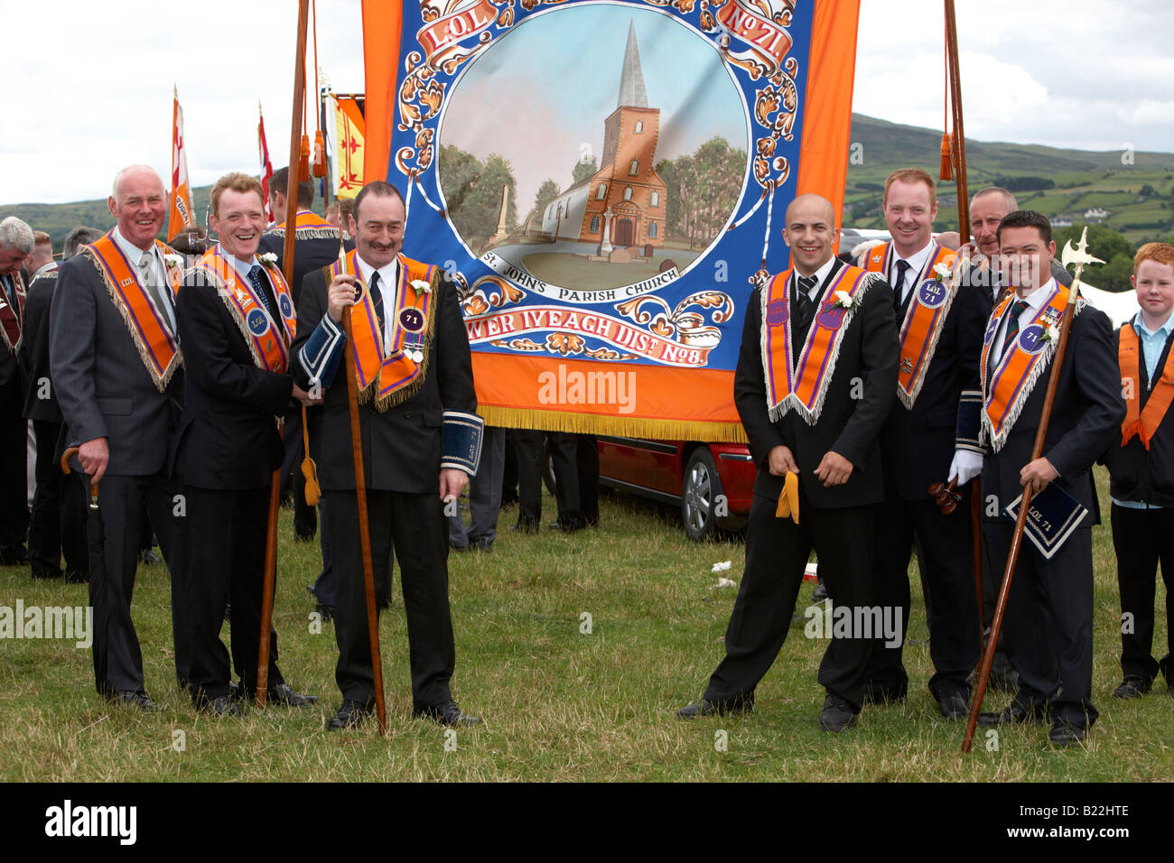 members of loyal orange order orangemen with banner in field during 12th July Orangefest celebrations in Dromara county down Stock Photo
