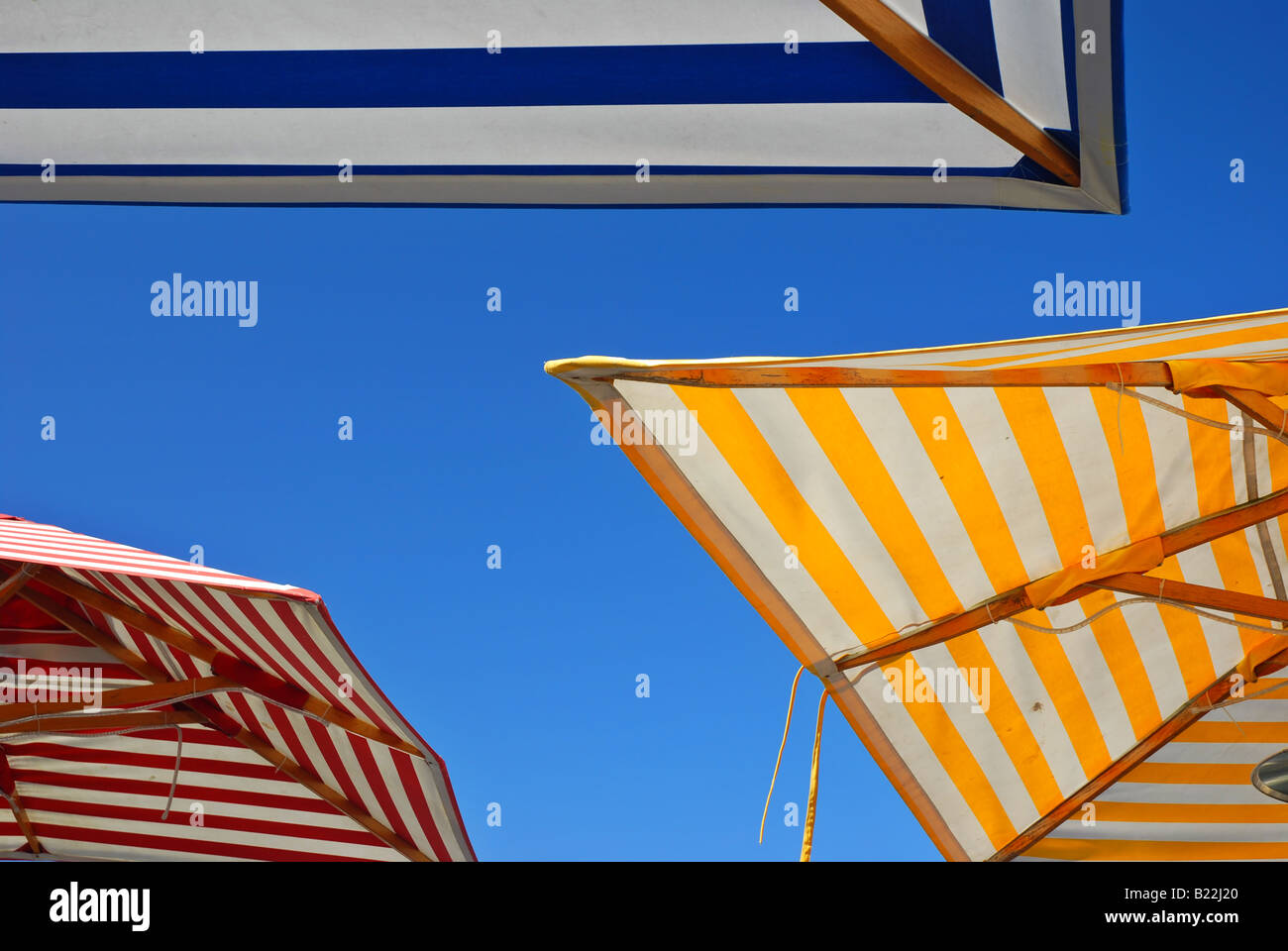 Three Picnic Table Umbrellas In Different Colors Outdoors Set Against A Three picnic table umbrellas in different colors outdoors set against a