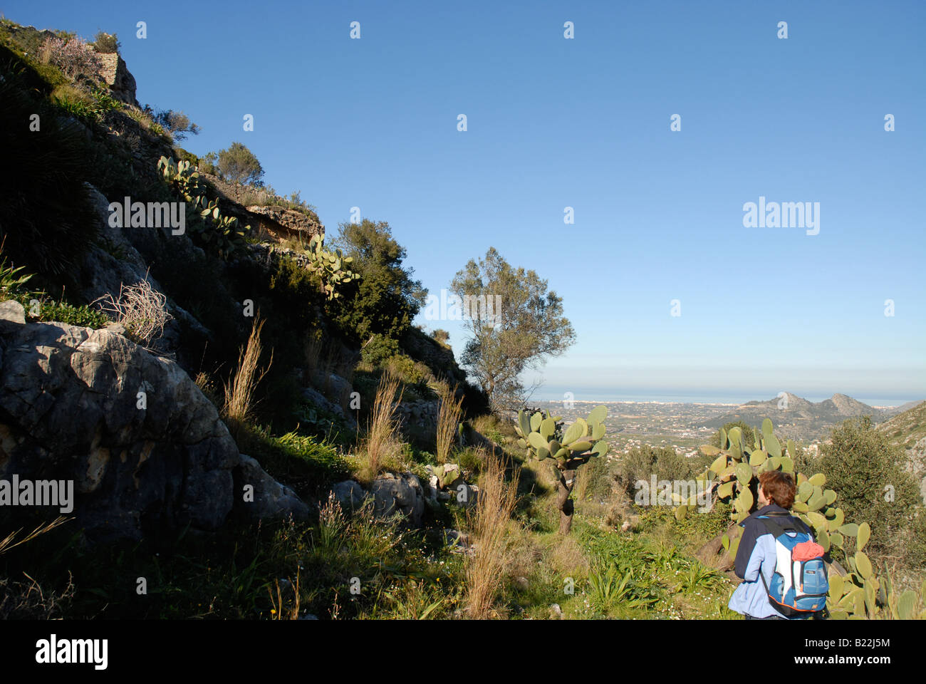 hiker and ruins of Pedreguer Castle, near Pedreguer, Marina Alta, Alicante Province, Comunidad Valenciana, Spain Stock Photo