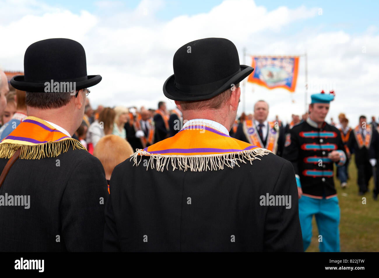 two loyal orange lodge orangemen watching parade wearing bowler hats