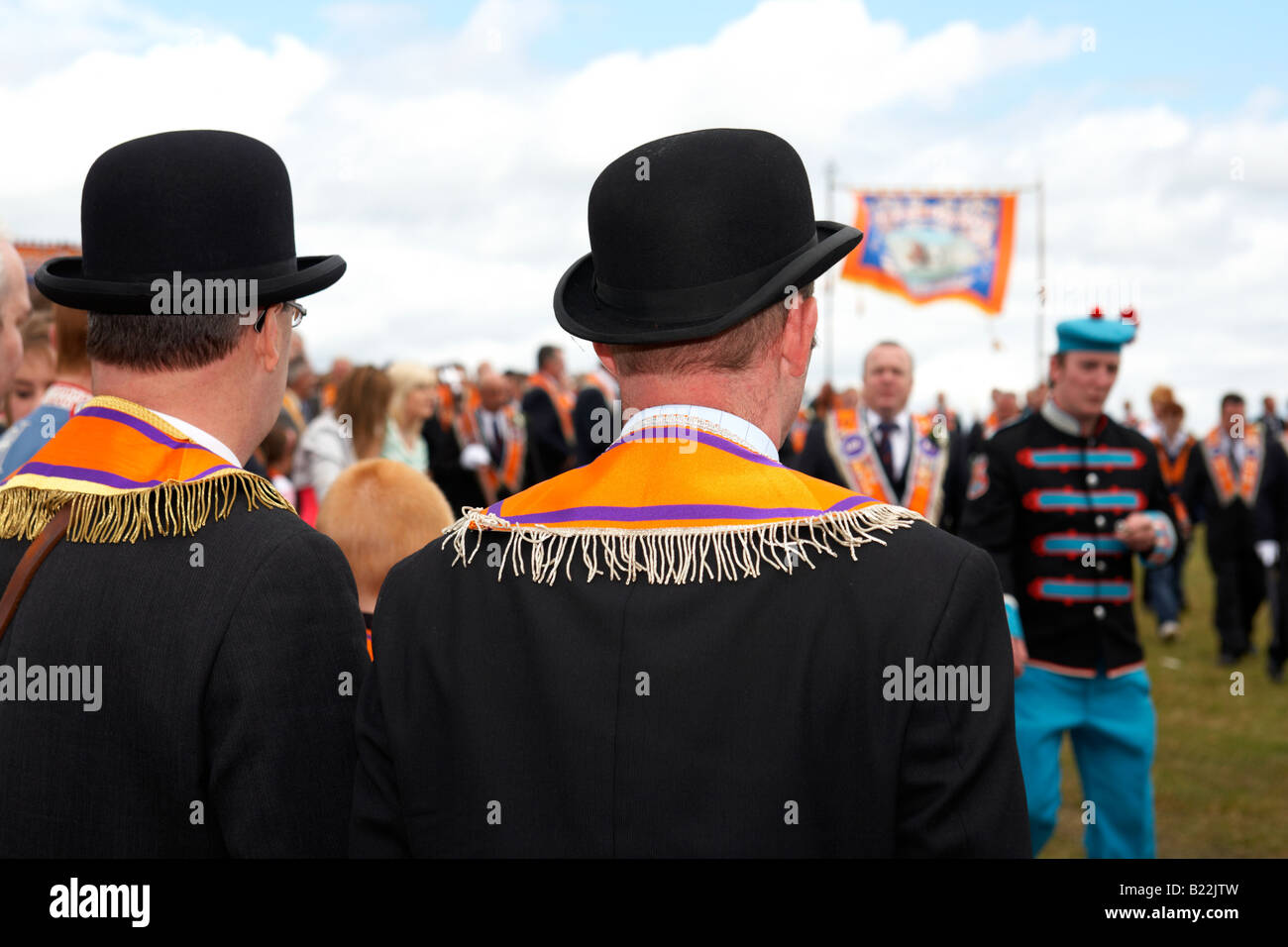 two loyal orange lodge orangemen watching parade wearing bowler hats during 12th July Orangefest celebrations in Dromara Stock Photo