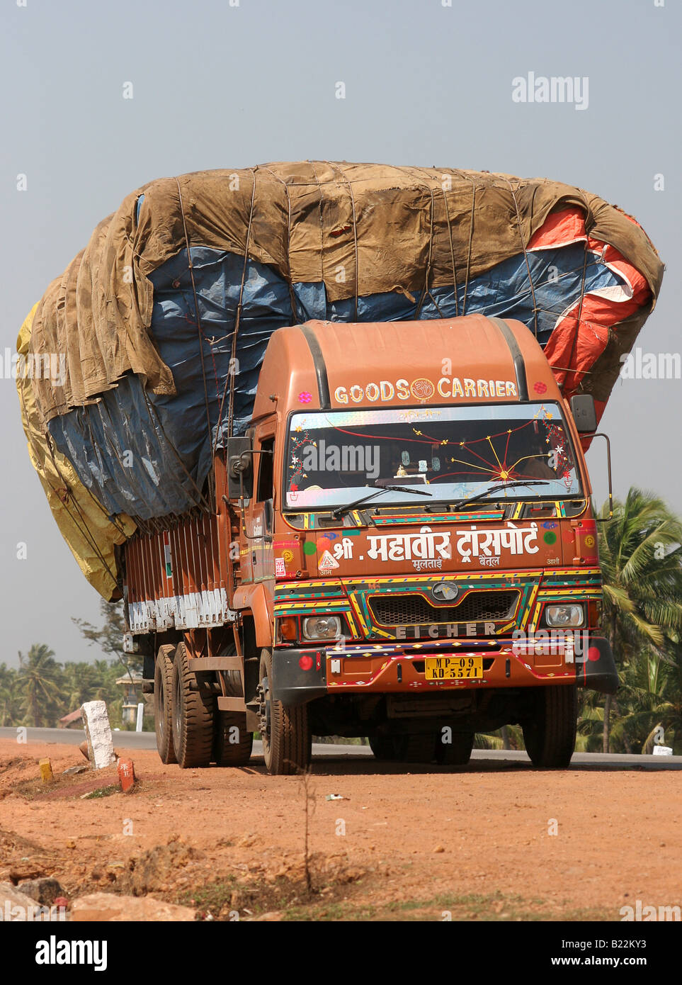 Overloaded Eicher truck parked next to the Arabian Sea near Kasaragod Kerala India Stock Photo