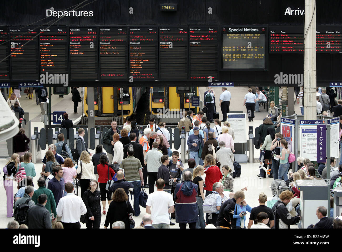 An elevated view of a busy concourse and notice board at Edinburgh's Waverley station at rush hour. Stock Photo