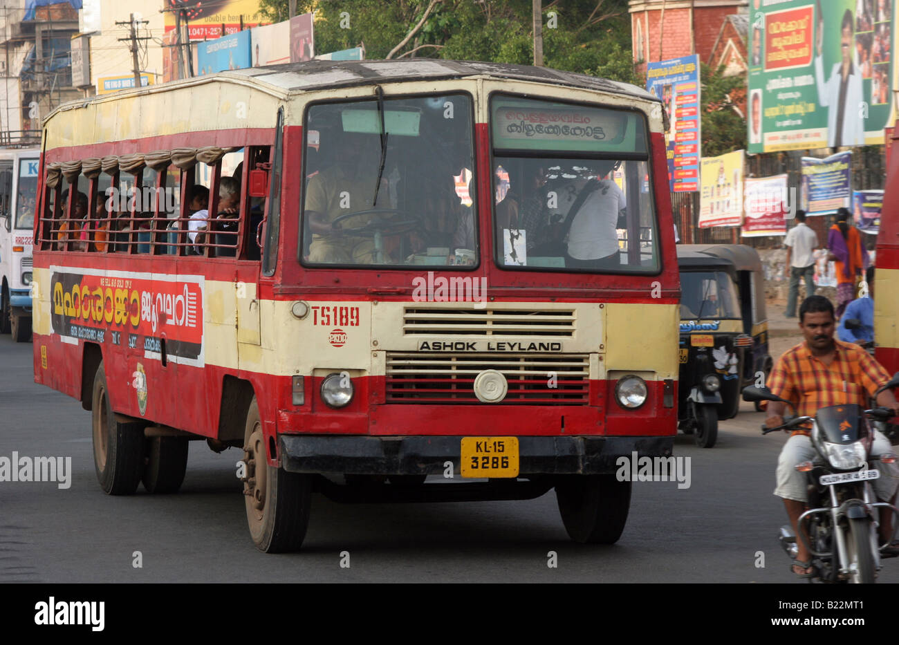 Ashok Leyland bus travels through heavy traffic at sunset in Thiruvananthapuram Kerala India Stock Photo
