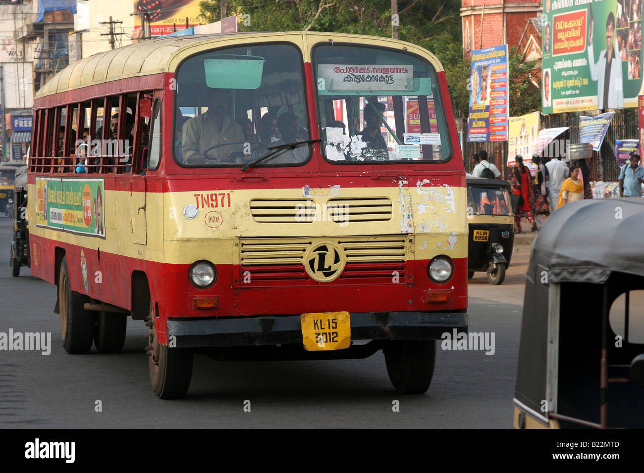 Ashok Leyland bus travels through heavy traffic at sunset in Thiruvananthapuram Kerala India Stock Photo