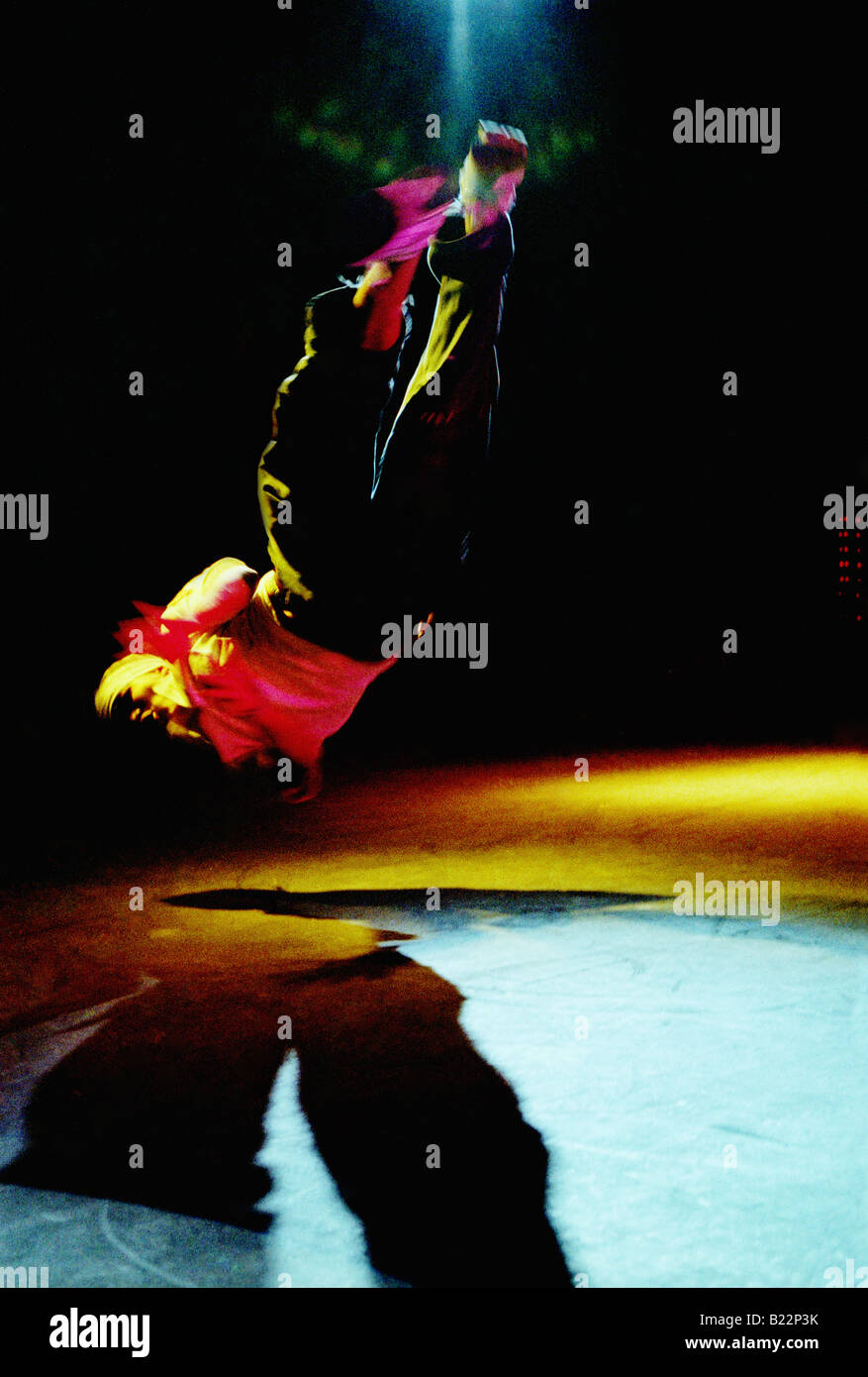 Break dancer spinning in midair on stage during a show Stock Photo
