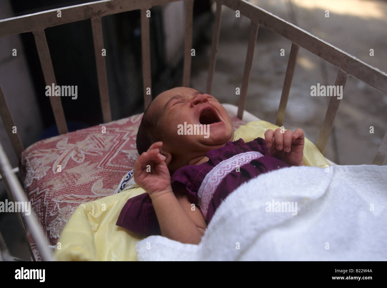 An Indian Baby Put Up For Adoption Lies In A Crib Stock Photo