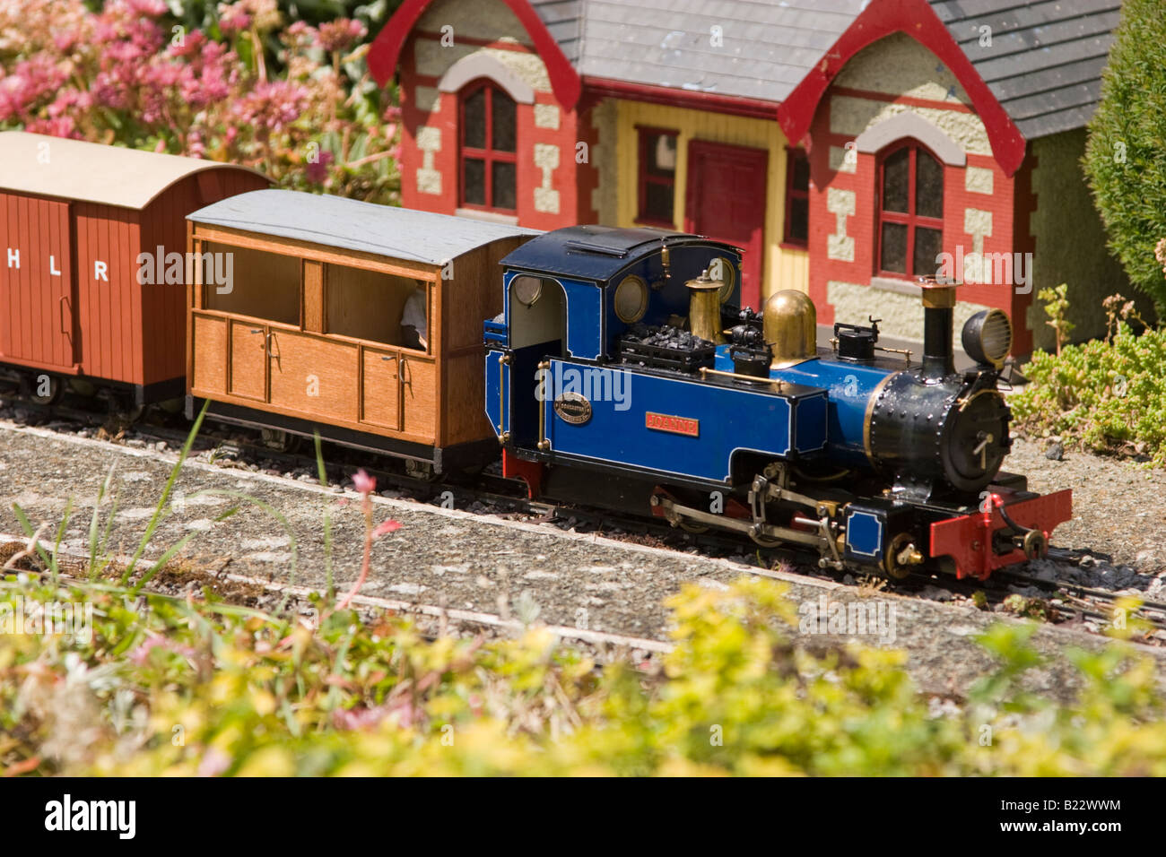 Model steam engine at station on garden railway Stock Photo