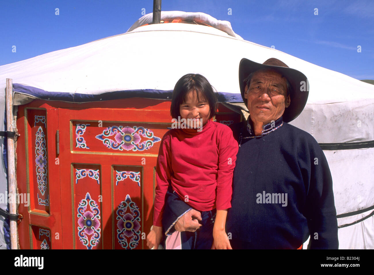 Senior man carrying his granddaughter Ulan Bator Independent Mongolia Stock Photo