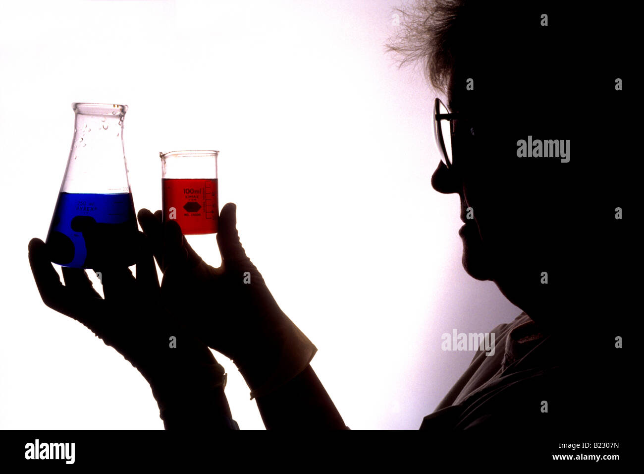 Silhouette of woman holding two beakers Stock Photo Alamy