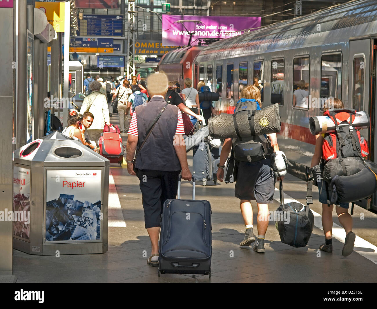 busy passangers with luggage baggage hurrying to train platform at the