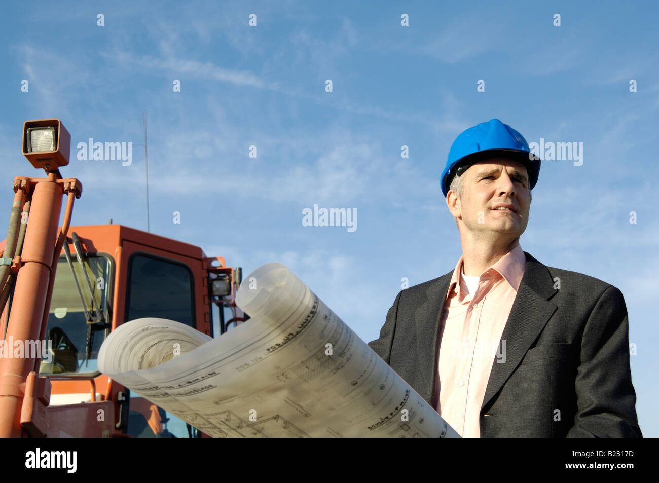 Male architect holding blueprints Stock Photo Alamy