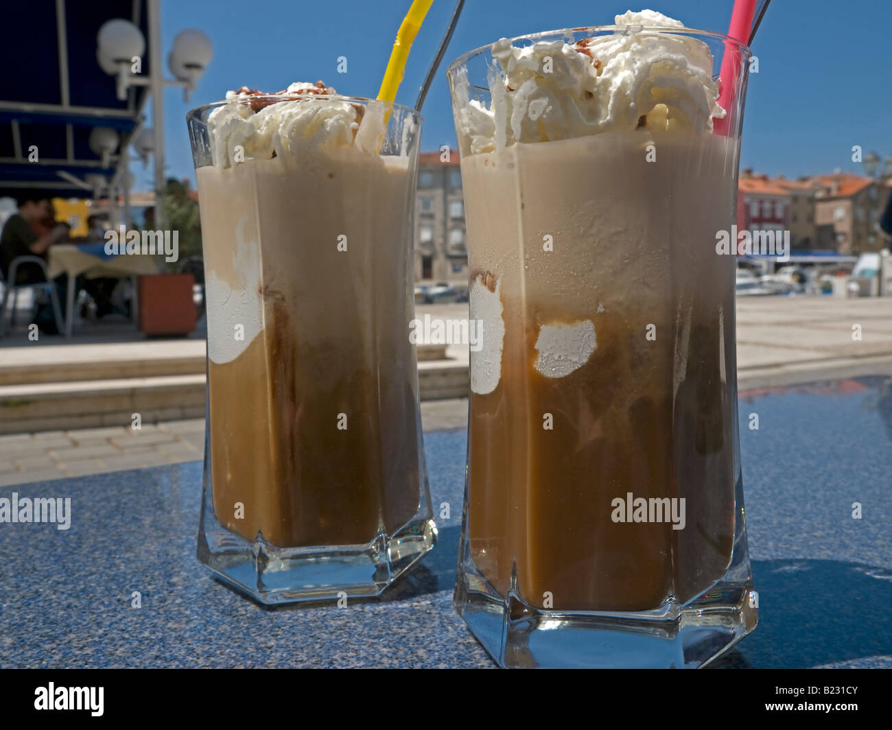 https://c8.alamy.com/comp/B231CY/two-glasses-with-ice-coffee-in-a-bar-in-the-town-cres-in-the-summer-B231CY.jpg