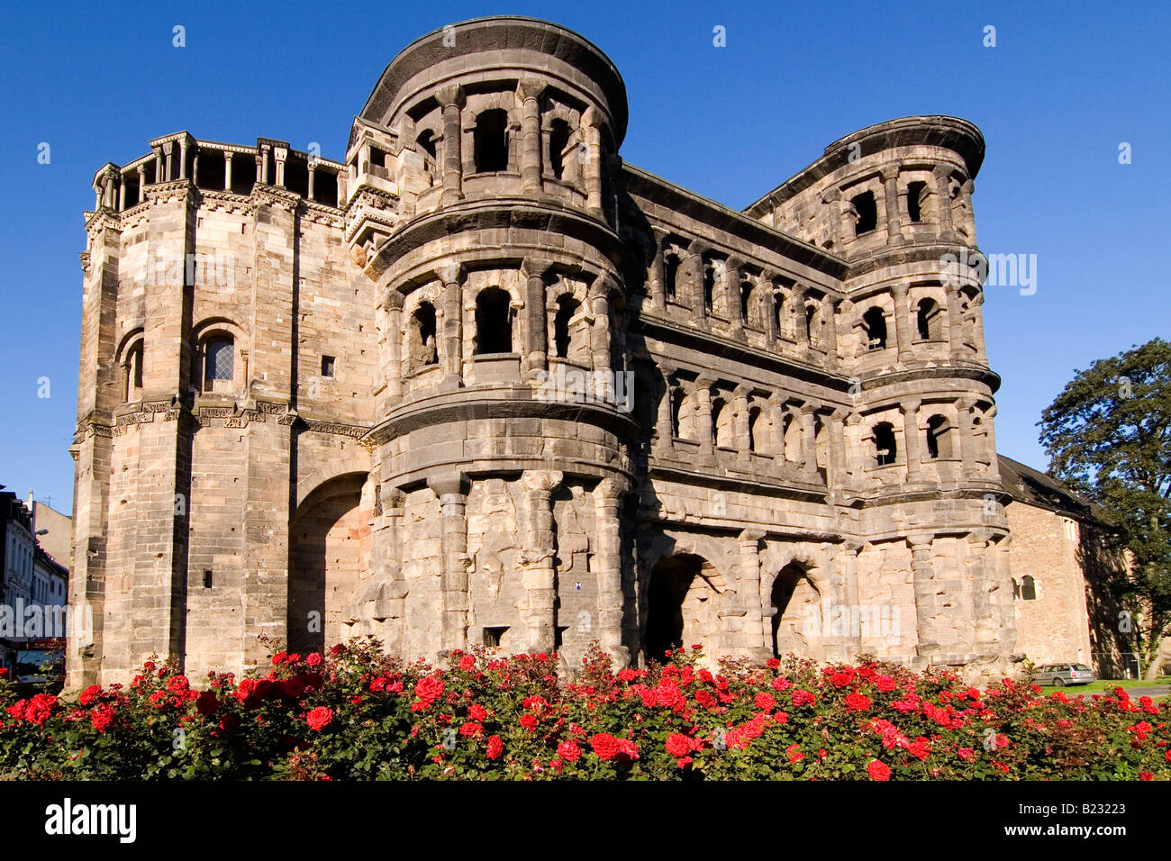 Flowers blooming in front of old roman building, Porta Nigra, Trier