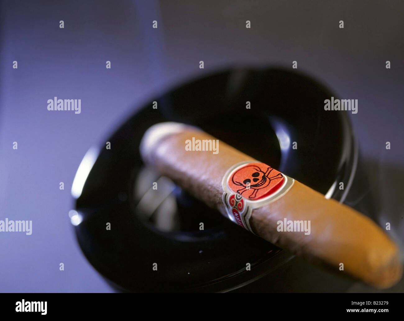 a cigar with smoke on the ashtray with skull and crossbones as a symbol
