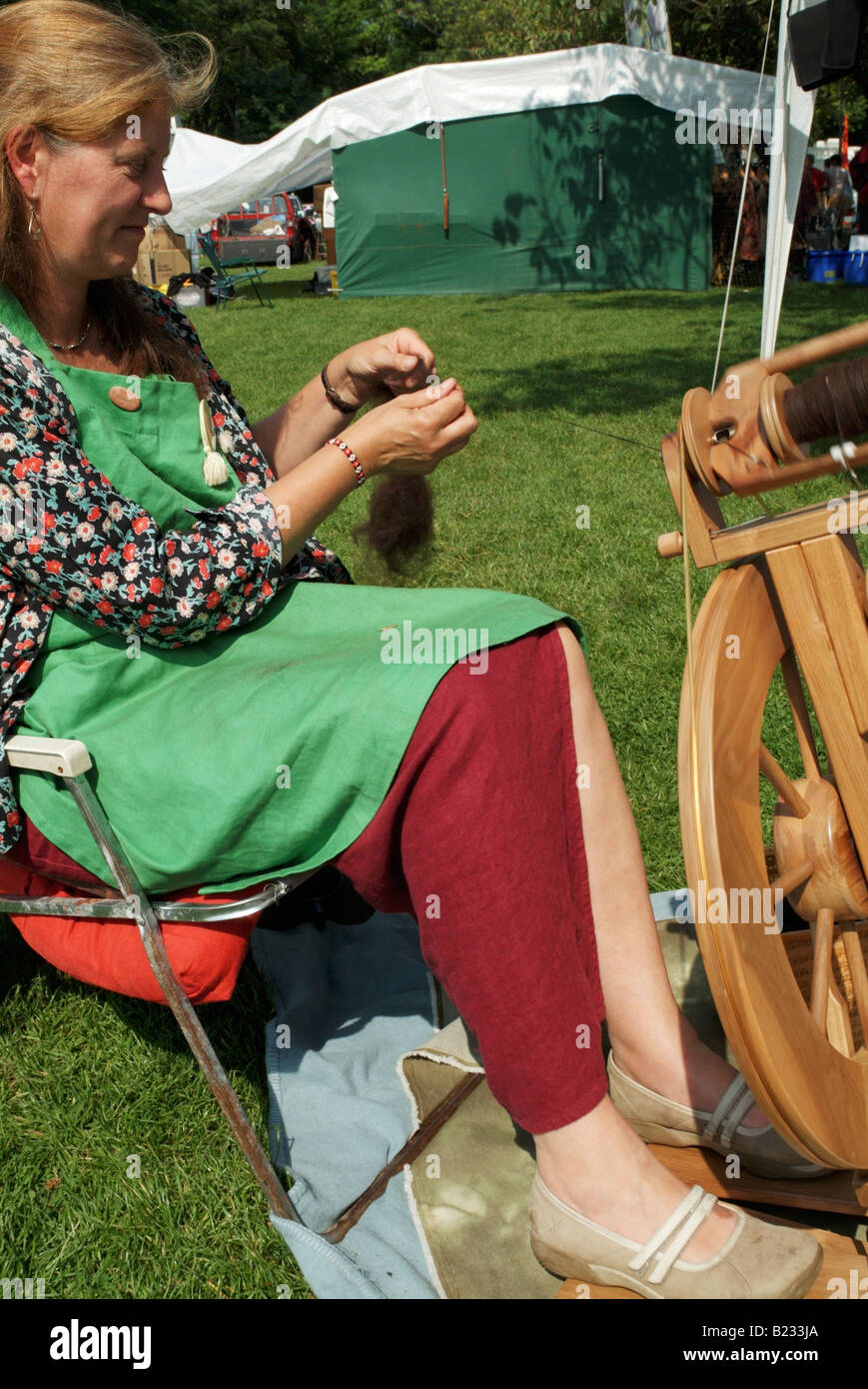 A woman demonstrating spinning wool at the 2008 Meadows Festival, Edinburgh (editorial only). Stock Photo