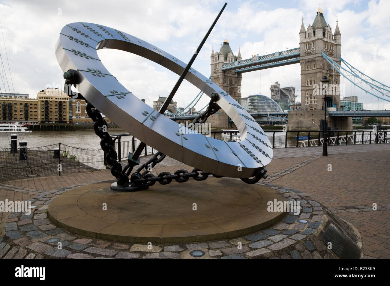 The Timepiece sculpture is on the banks of the Thames with Tower Bridge in the background Stock Photo