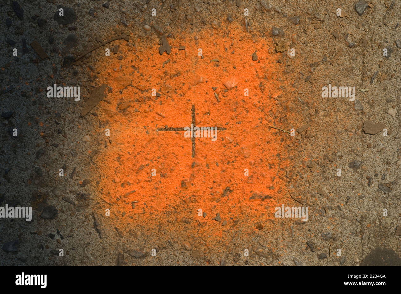 Close up of orange paint with a surveyor s mark on a conglomerate