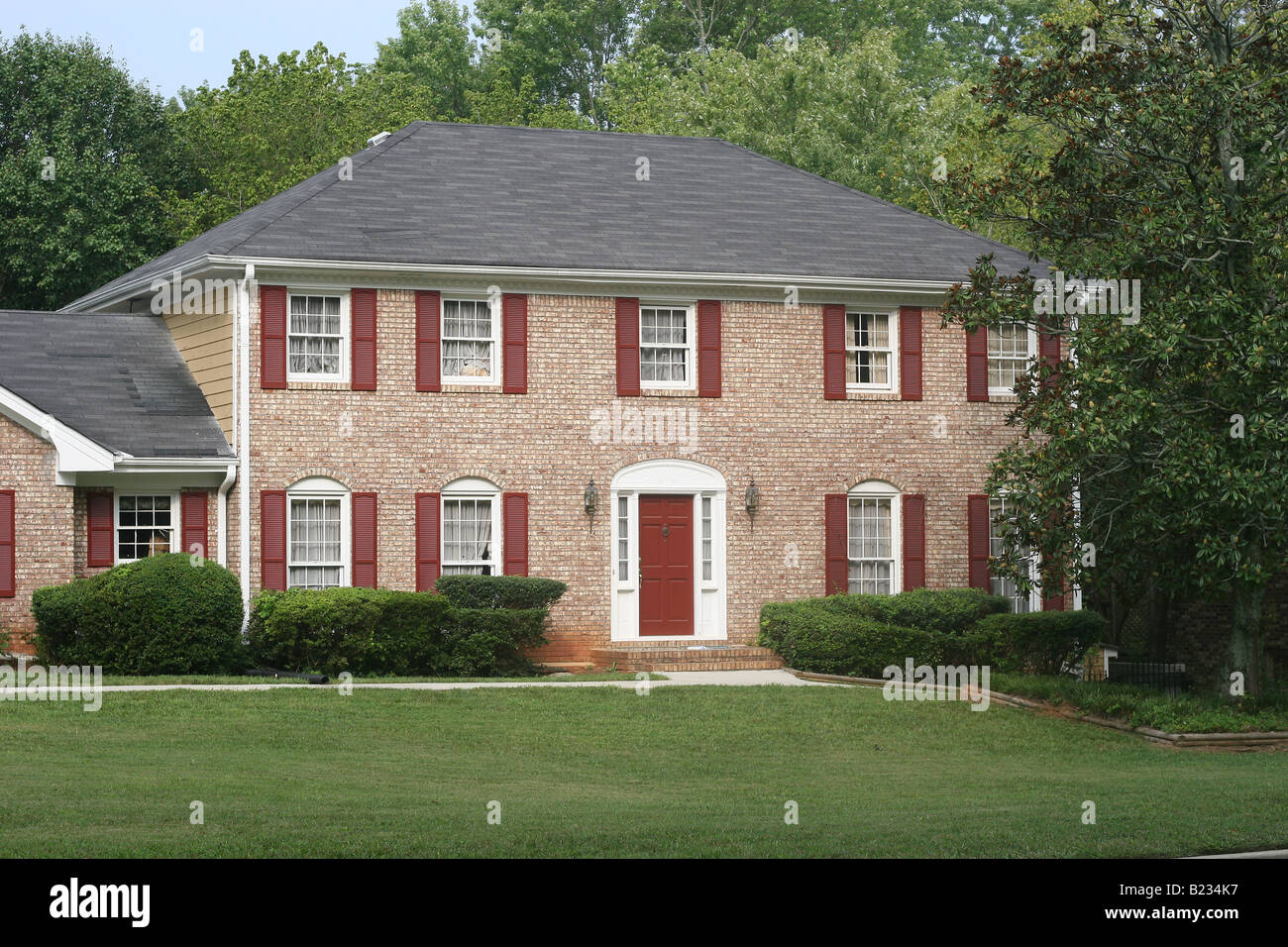 A nice two story brick house with red trim Stock Photo Alamy