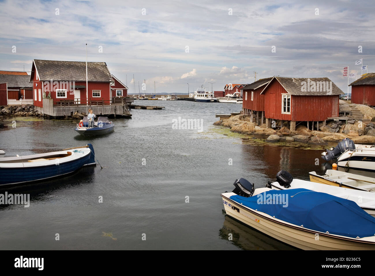 Boats on mooring and old fishing cabins at Knippla Island in Northern