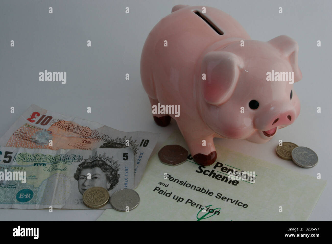 Company pension scheme statement together with money and piggy bank. Stock Photo