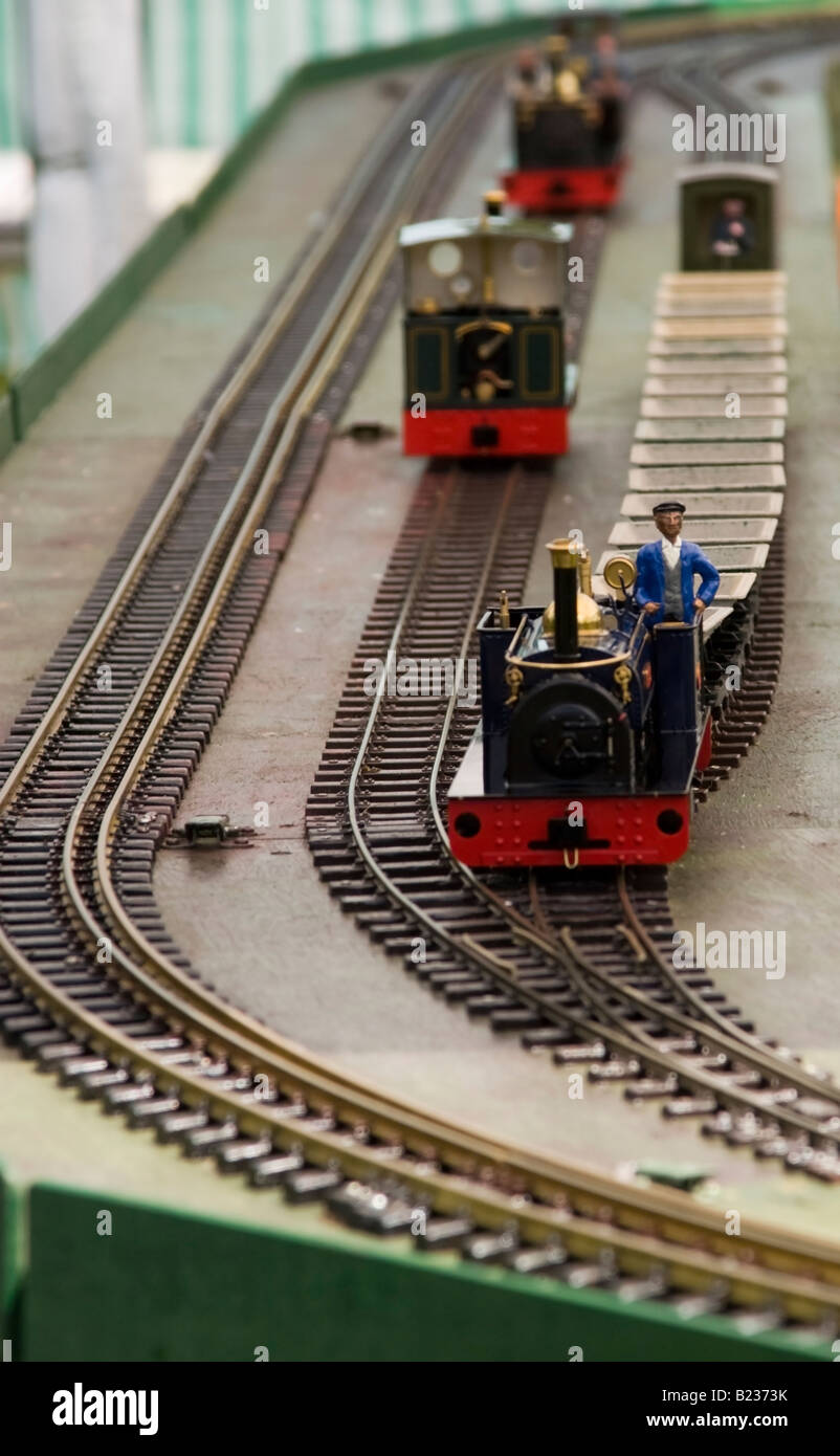 Model steam railway engine pulling tipping trucks Stock Photo