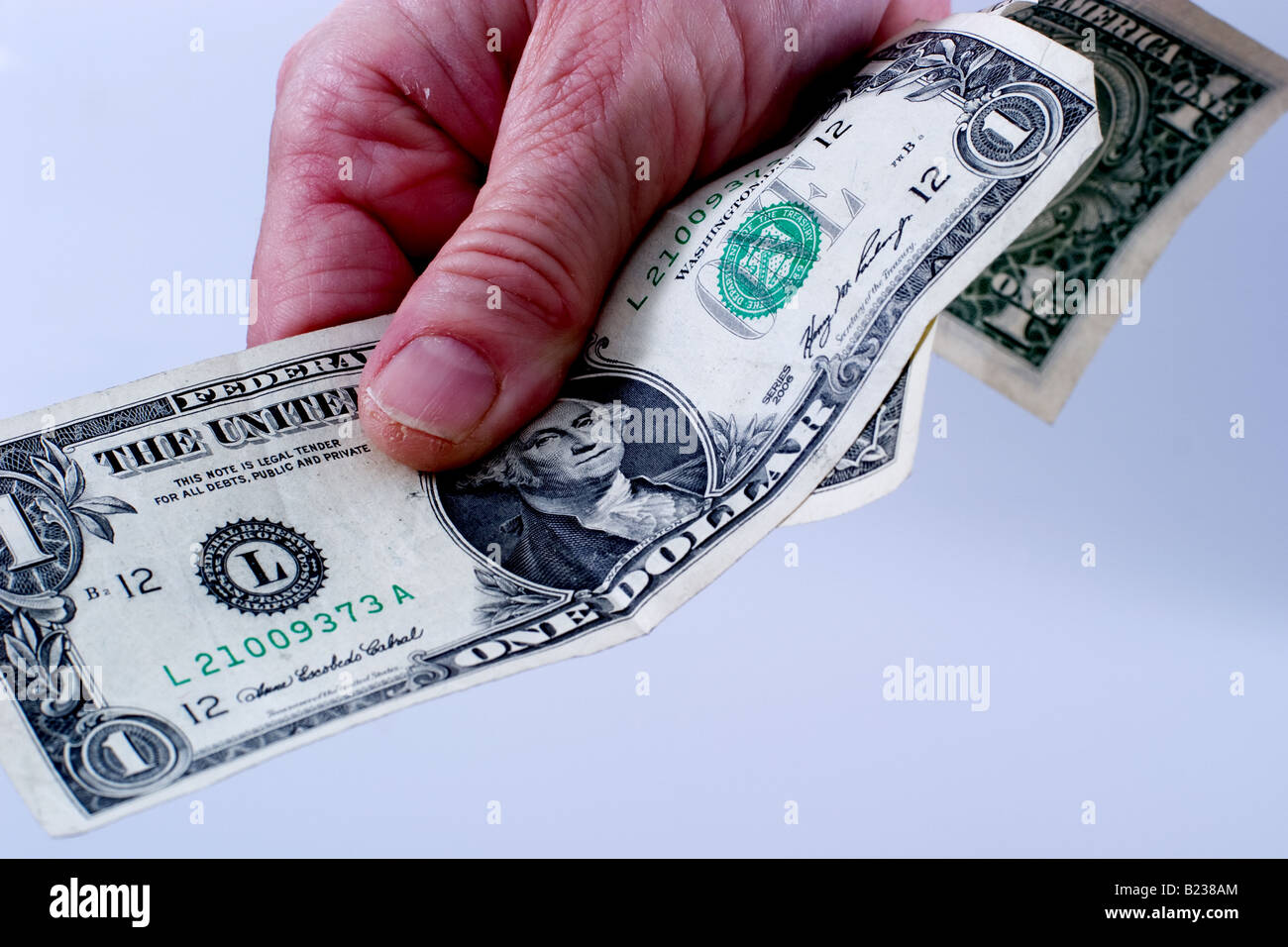 Woman holding two dollar bills of American currency Stock Photo