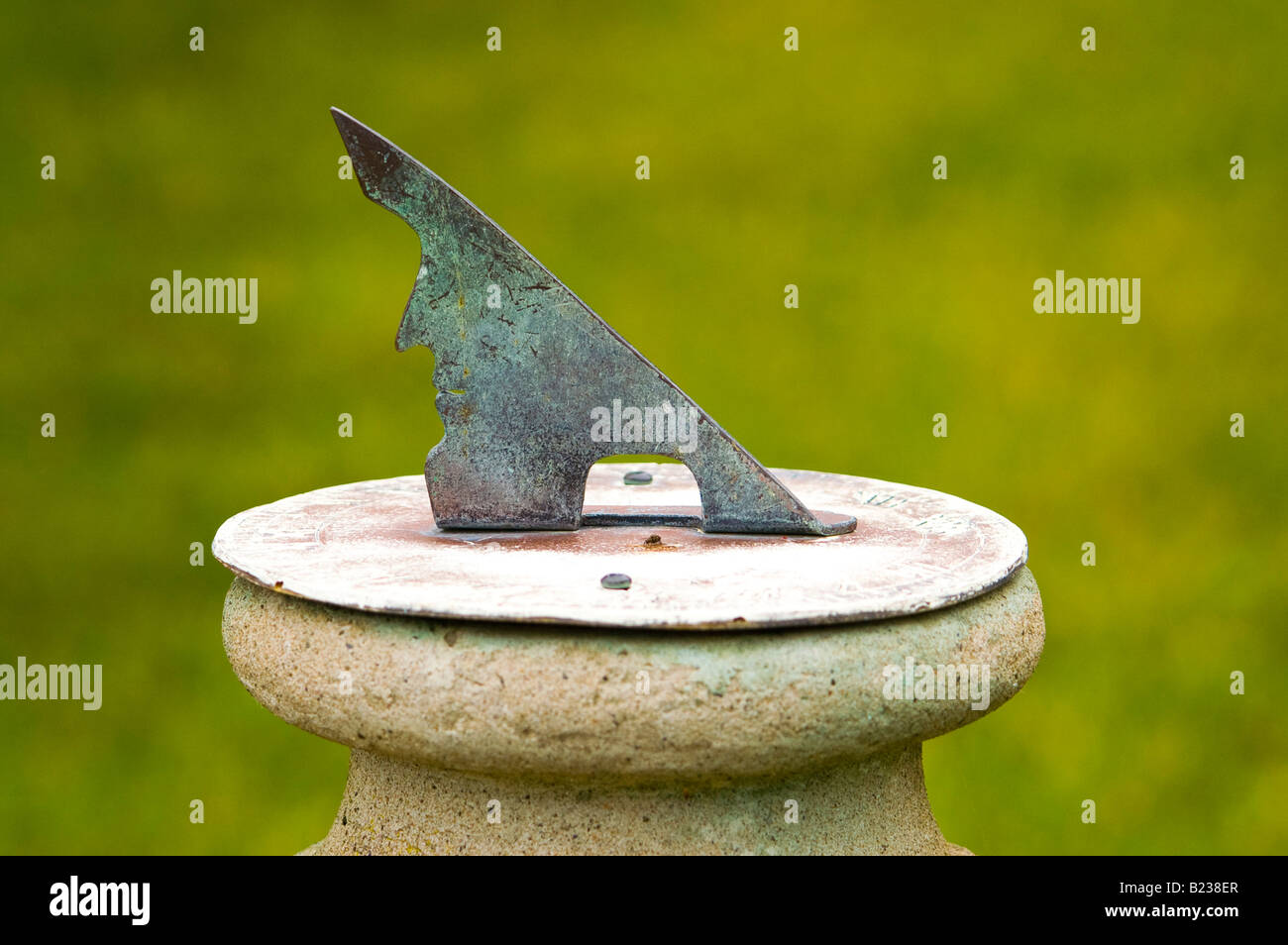 A sun dial with the outline of a human face. Stock Photo