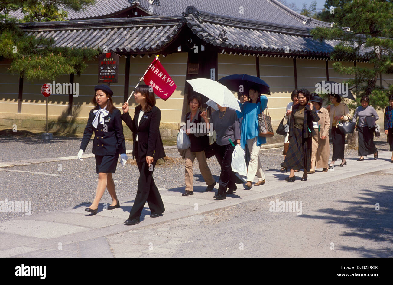 Japanese tour group leader through hires stock photography and images