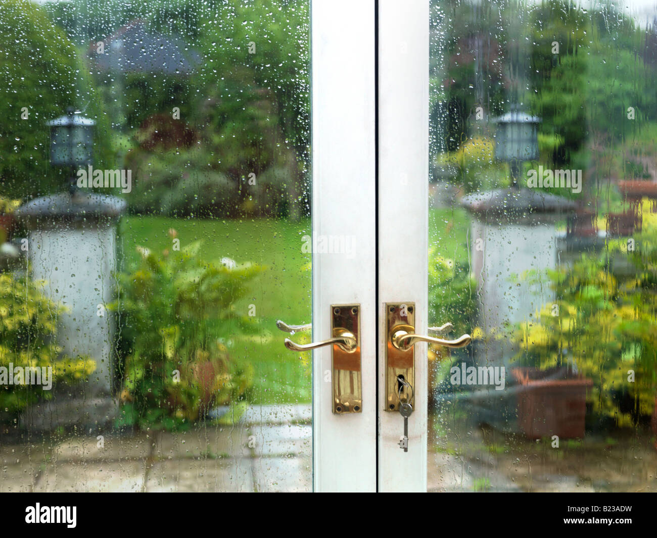 Garden in the Rain through French Windows Stock Photo