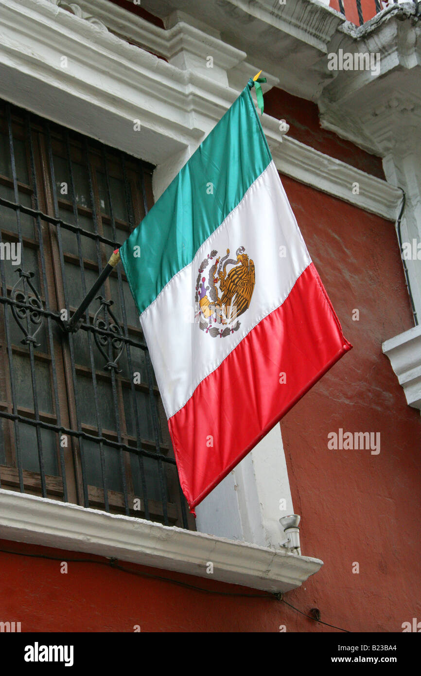 Mexican Flag Flying from an Old Colonial House in Puebla City, Mexico Stock Photo