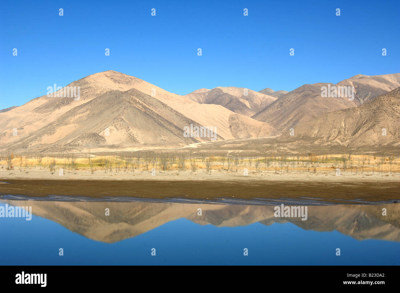 Reflection of mountains in water, Tibet, China Stock Photo