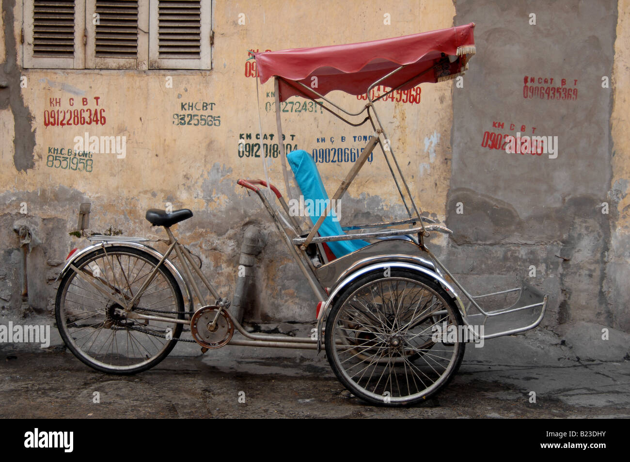 Rickshaw parked at roadside, Hanoi, Vietnam Stock Photo