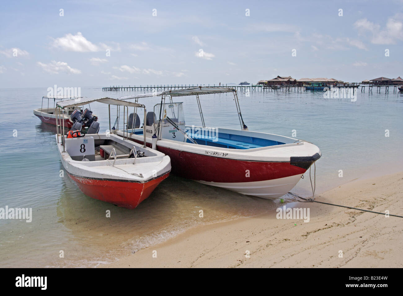 Borneo Divers boats pulled up on the beach at Mabul Island Resort nr Sipadan Sabah Malaysia Stock Photo