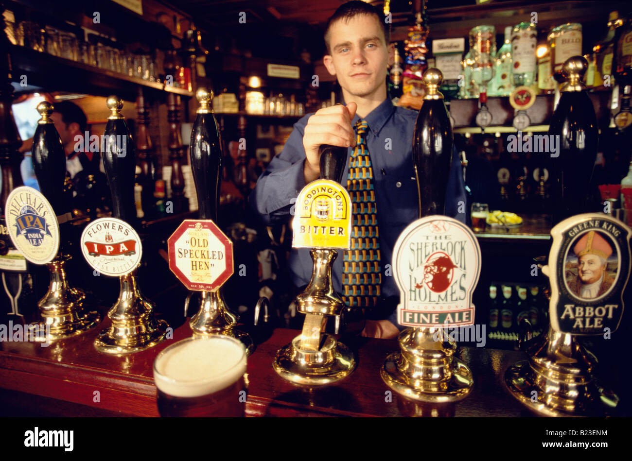 Beer on tap barman at The Sherlock Holmes Pub London Stock Photo