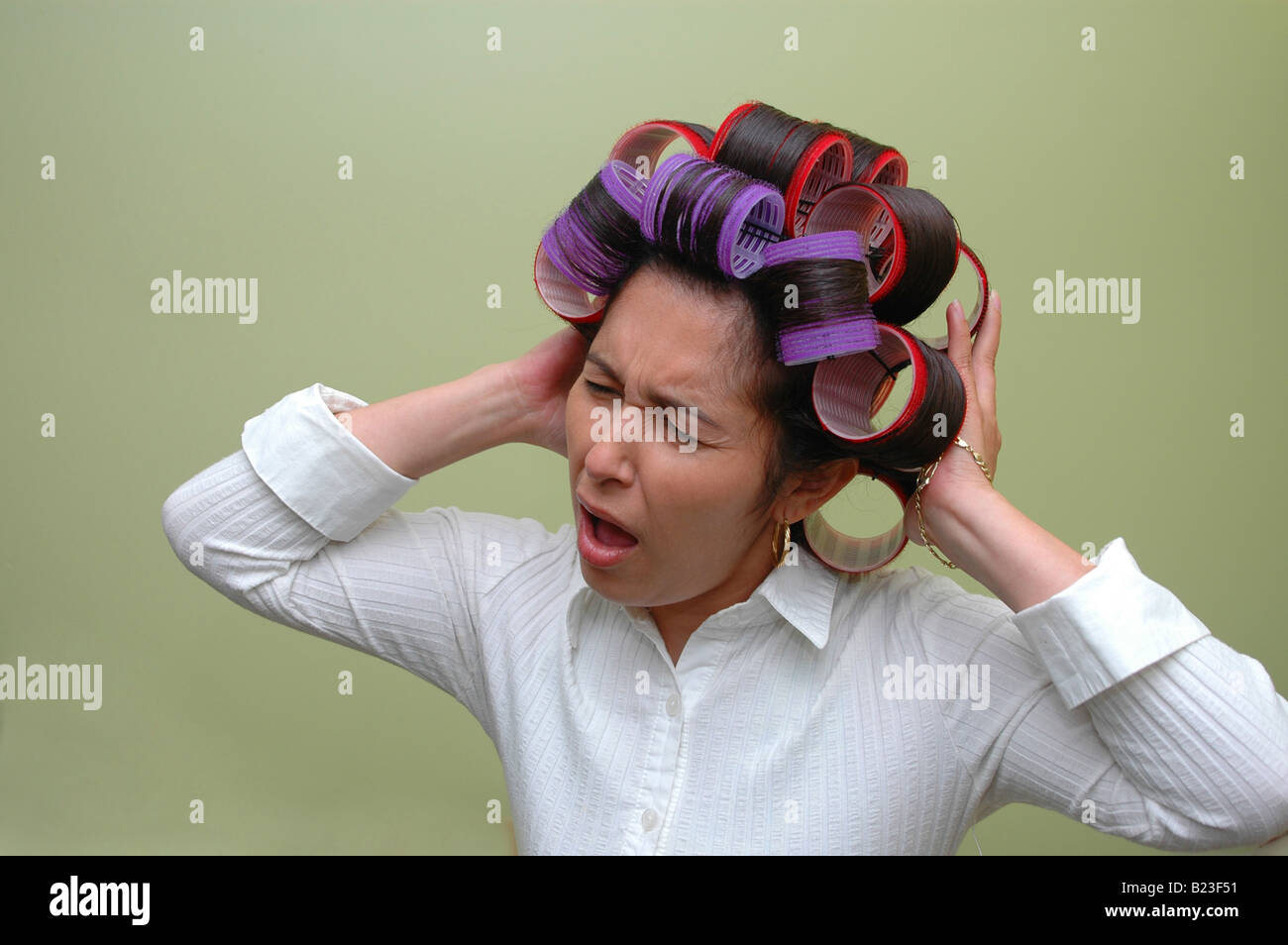 Woman wearing hair rollers Stock Photo Alamy