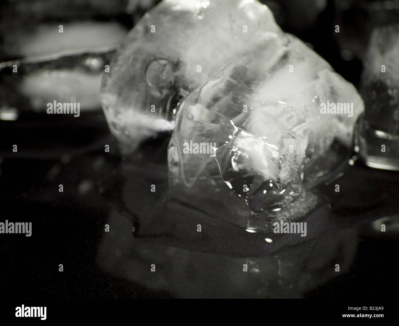 Melting ice on a reflective black surface Stock Photo - Alamy