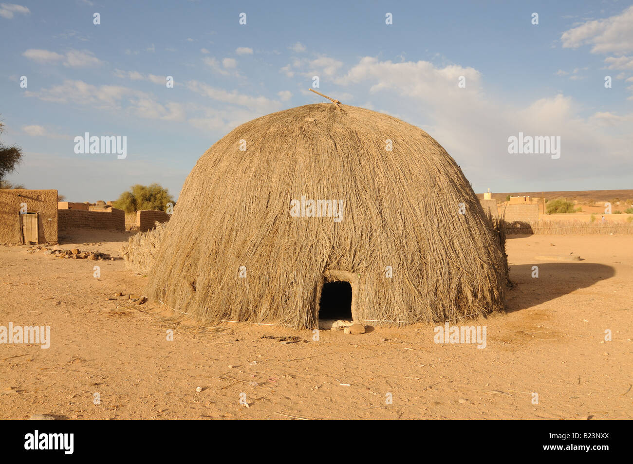 Traditional house made of straw on the countryside in the saharan desert Western Africa Mauritania Africa Stock Photo