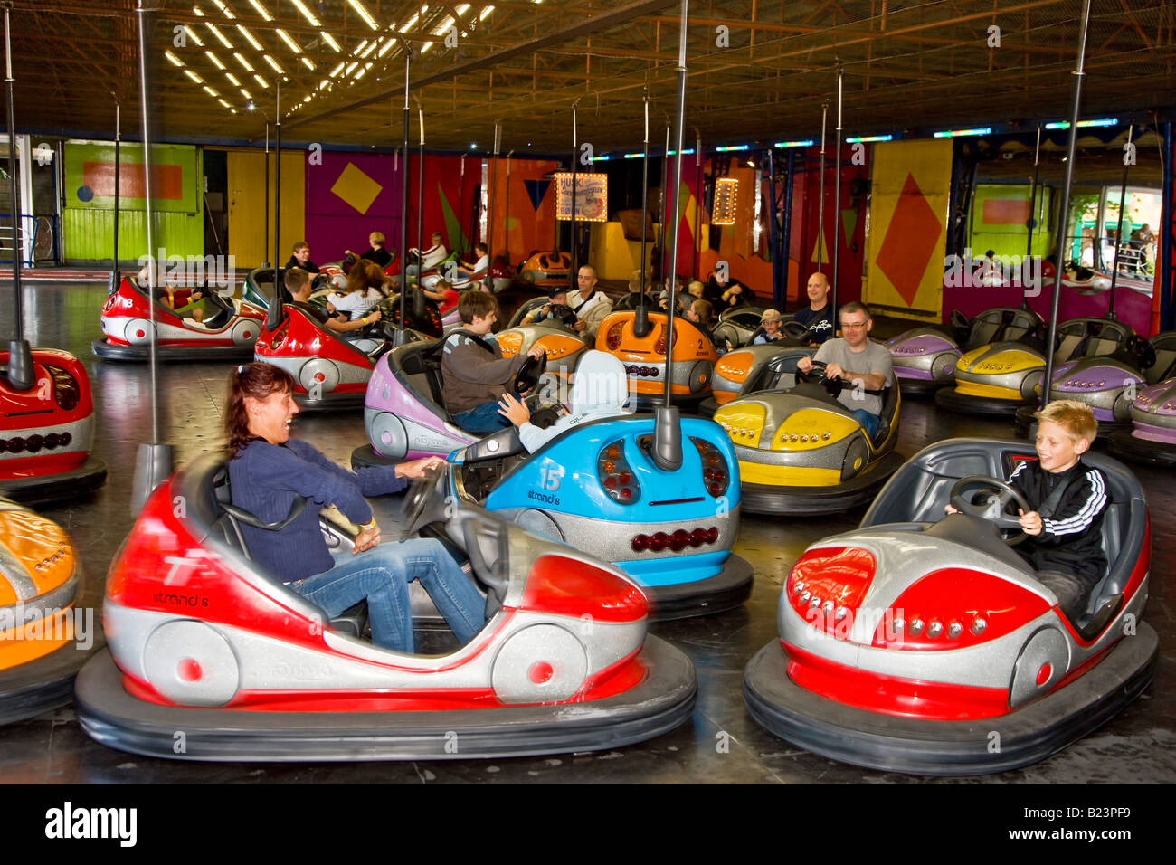 Driving bumper cars in Bakken amusement park Stock Photo