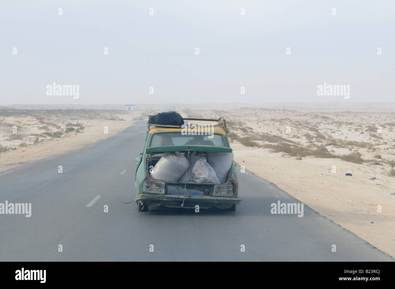 Heavy loaded old Renault on the road between Nouadhibou and Nouakchott Western Africa Mauretania Africa Stock Photo