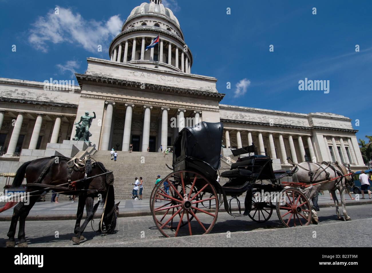 A horse drawn carriage waits to pick up tourists in front of the Capitolio in Havana, Cuba Stock Photo