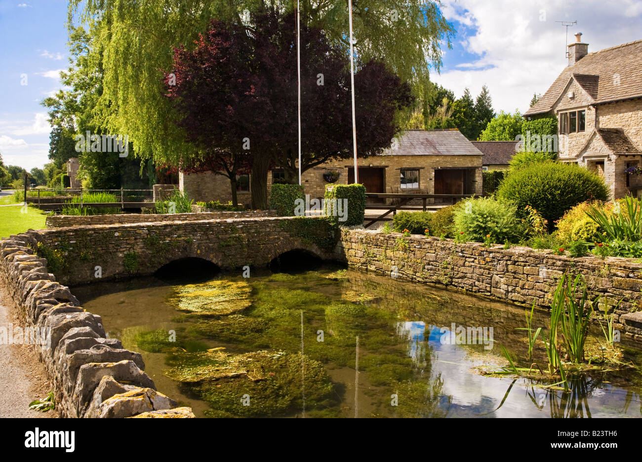 The River Thames flowing past Cotswold stone country houses in the