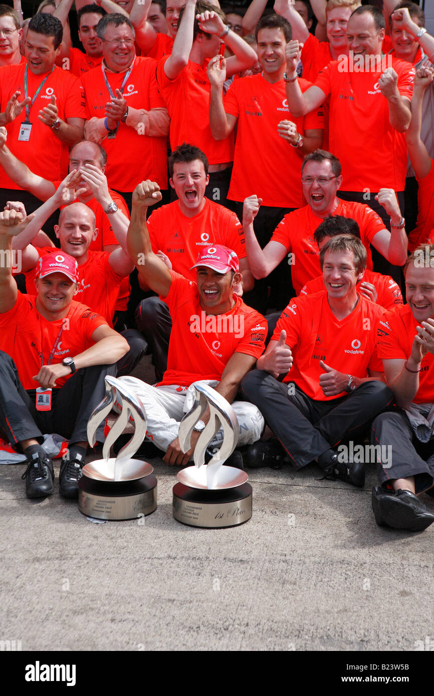 Lewis Hamilton celebrates victory at the 2008 F1 British Grand Prix with his McLaren team mates Stock Photo