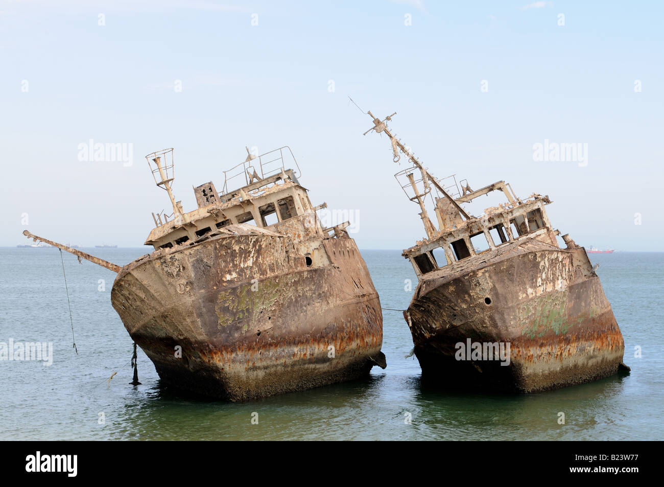 Ship wrecks rusting on the shores of the beach of Nouadhibou one of the largest ship wreck cemeteries worldwide Western Africa Stock Photo